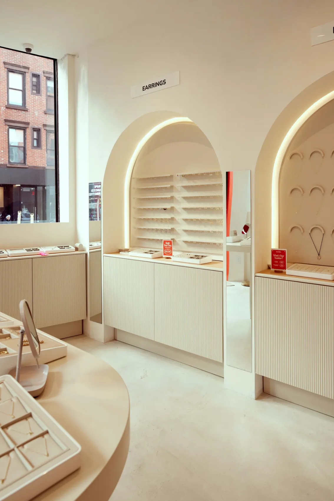 Store interior with arched wall displays and a street window