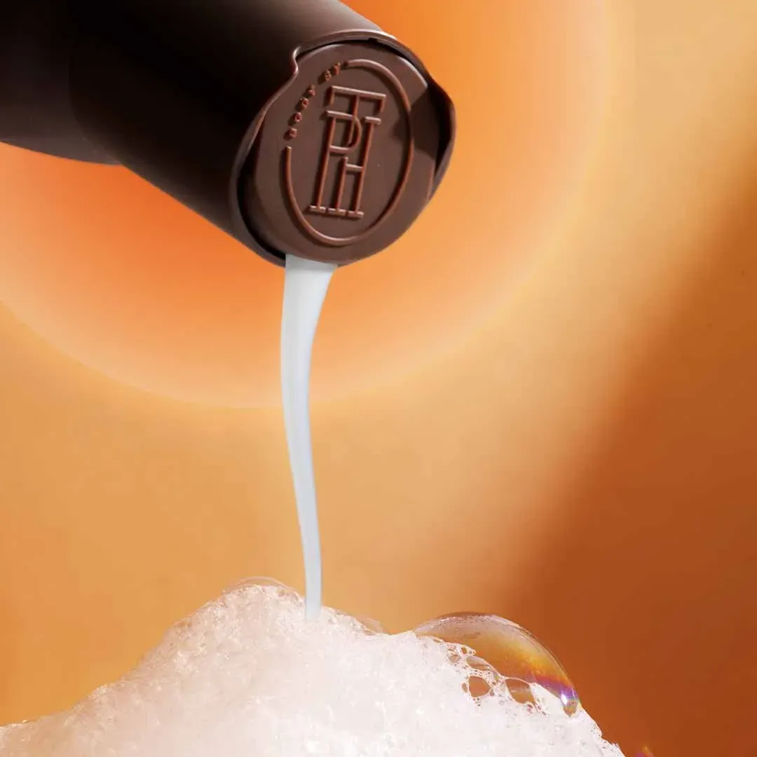 Lotion pouring from a TPH bottle onto foam