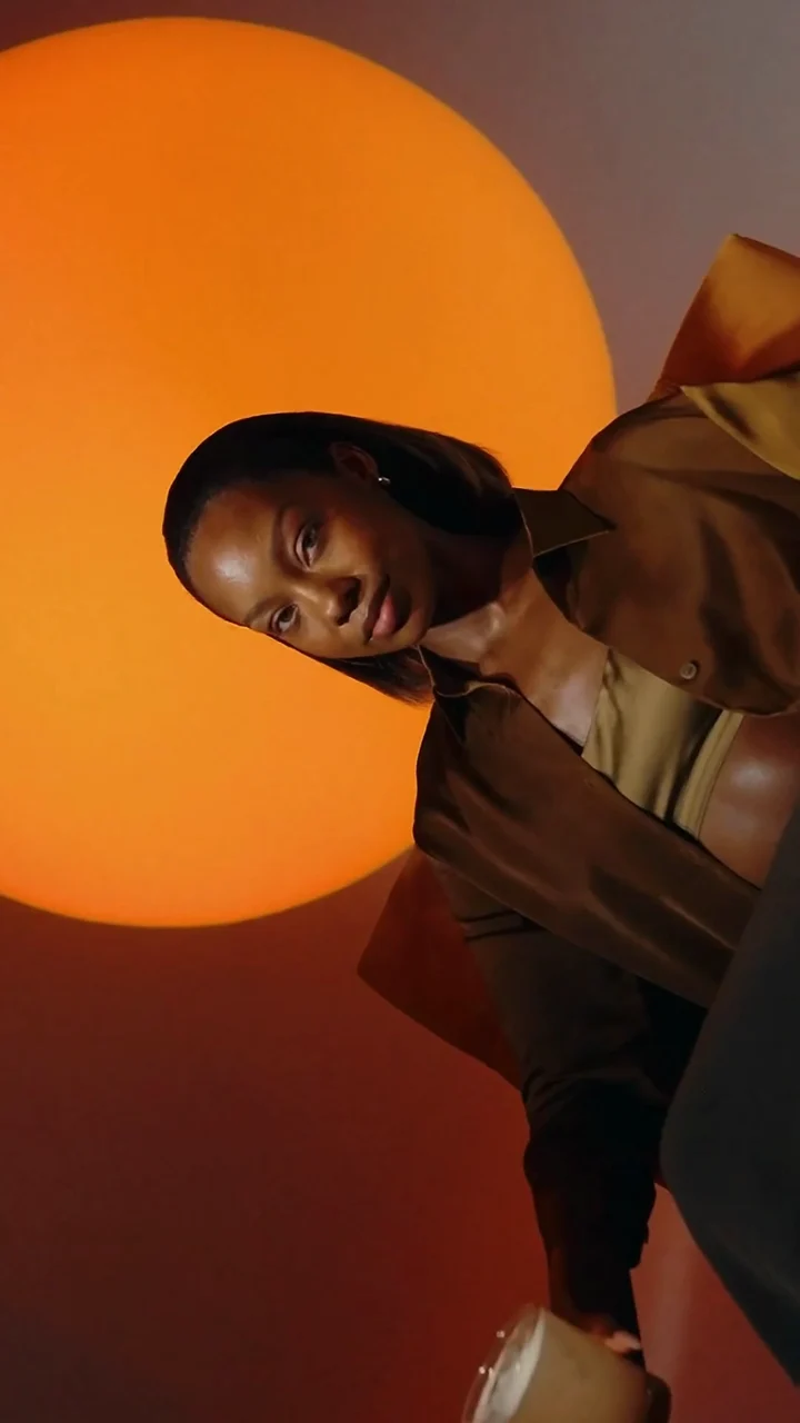 Still from the Arctic Chai launch film: a model in a brown jacket against an orange sun