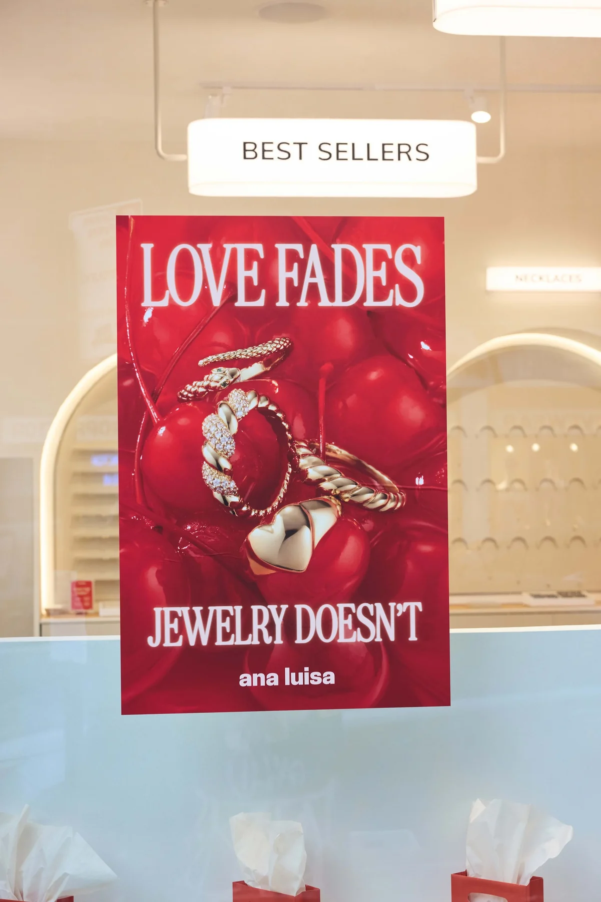 “Love fades, jewelry doesn’t” poster above the best sellers