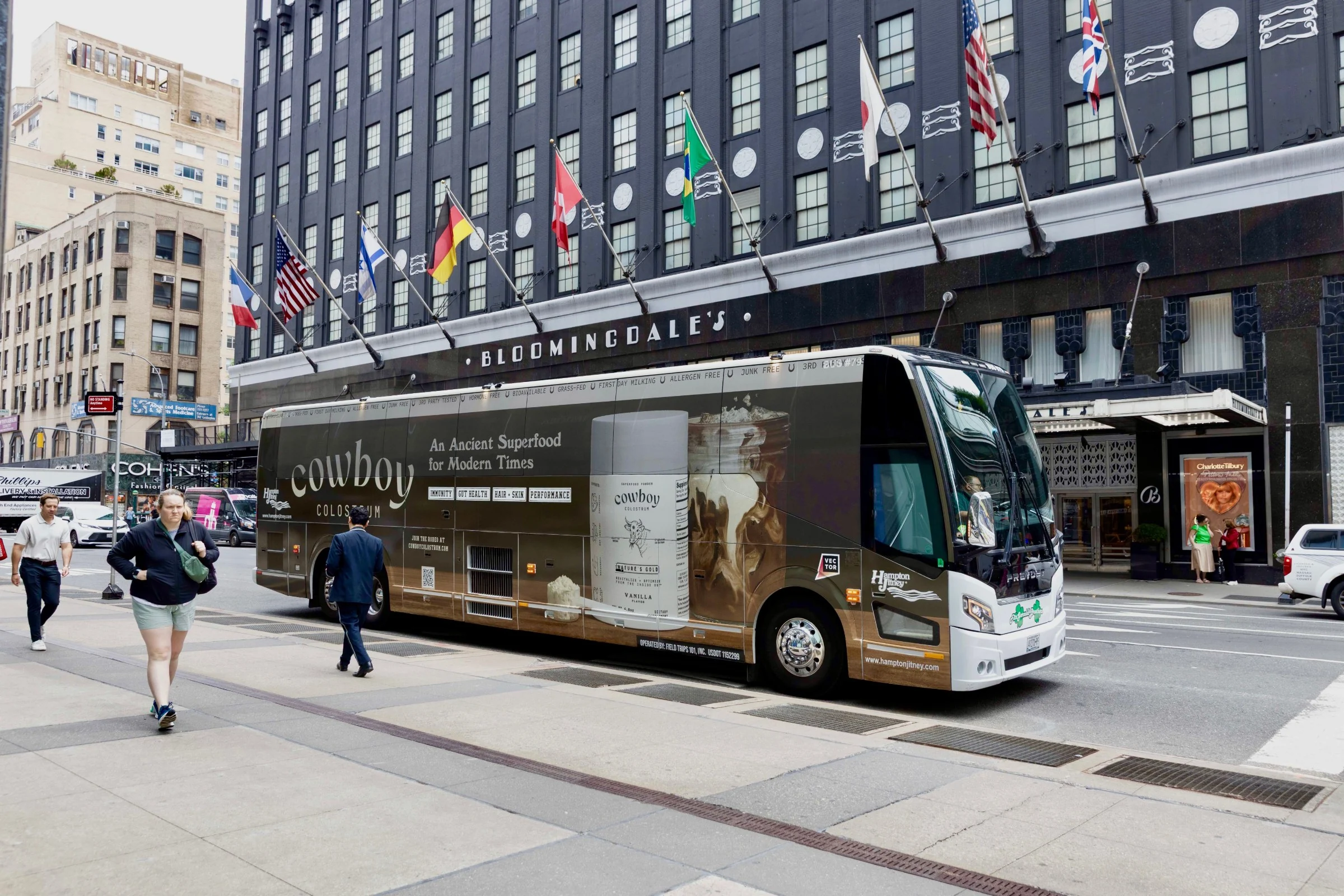 The Cowboy Colostrum coach wrap on a Hampton Jitney outside Bloomingdale’s, New York